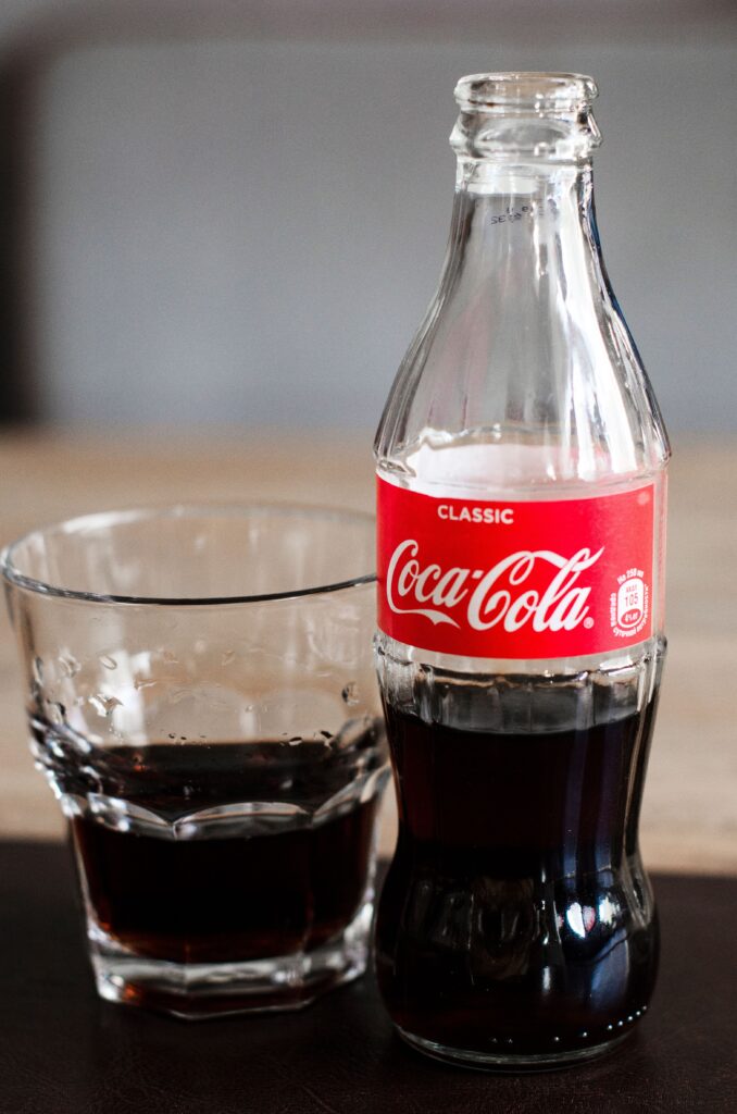 Foods that trigger diverticulitis flares: kombucha, compared with COCA COLA, an image of coca cola, in regards to achieving Loggins, gut health coach, 40 years, and author, gut health books.